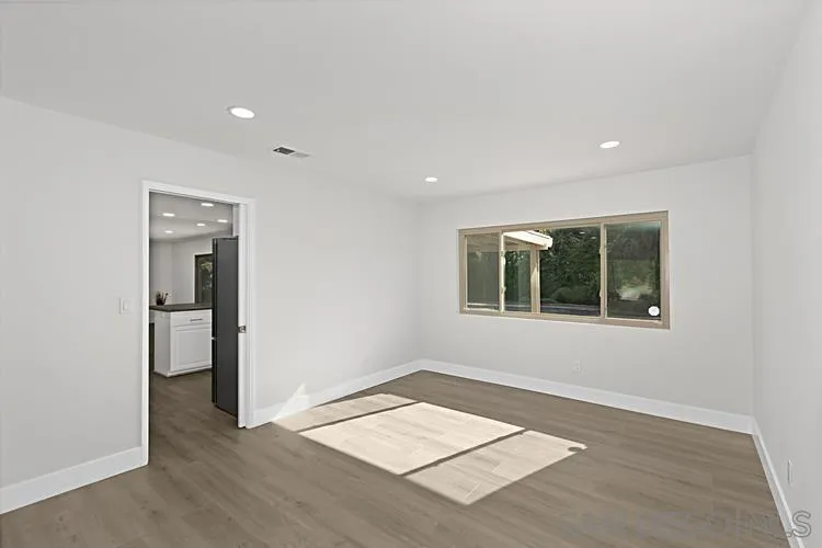 4334 Corral Canyon Road Bonita, CA 91902 - Photo 10 of 32 an empty room with wooden floor and a window