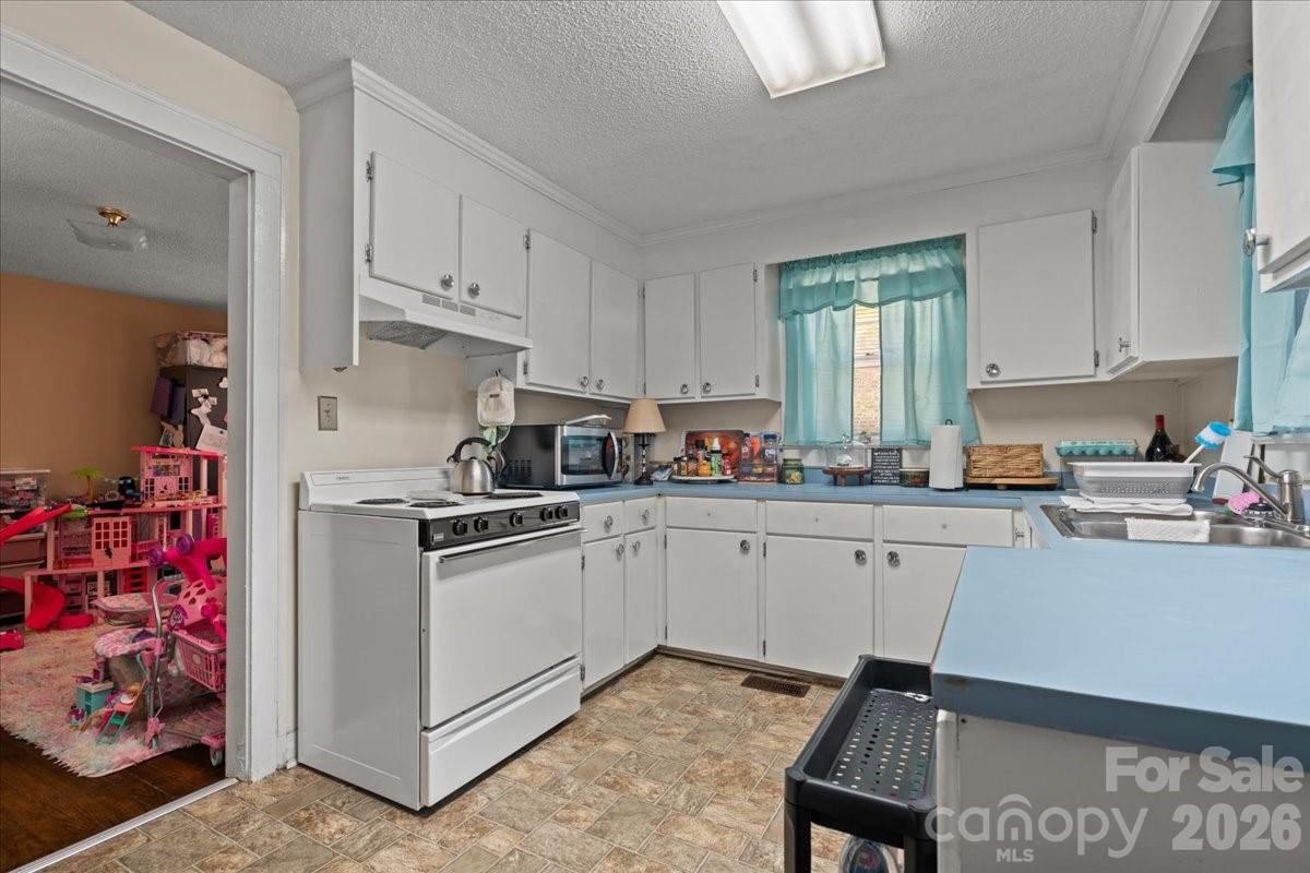 501 Church Street Cheraw, SC 29520 - Photo 40 of 48 a kitchen with cabinets appliances and a window