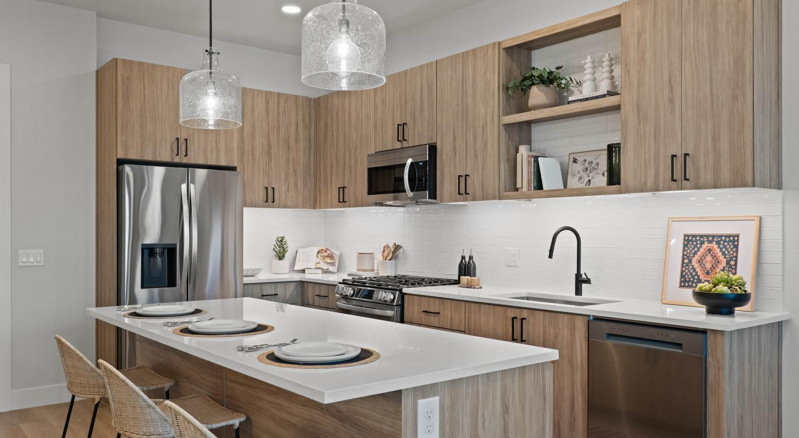 500 East Rivulon Boulevard, Unit C1 Gilbert, AZ 85297 - Photo 21 of 33 a kitchen with stainless steel appliances granite countertop a sink a stove a refrigerator and island with wooden floor