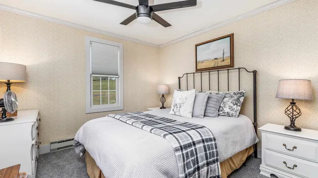 a bedroom with a bed and a night stand