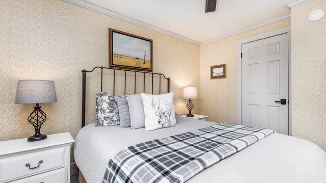 a bedroom with a bed and a lamp on table