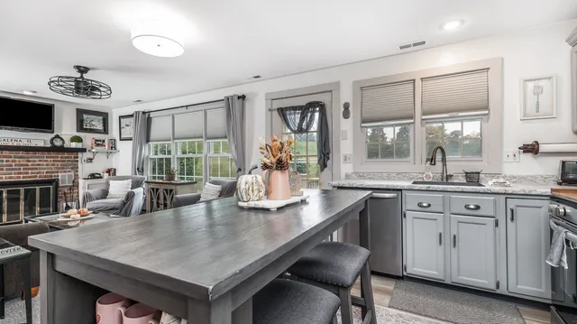 a kitchen with a table chairs sink and cabinets