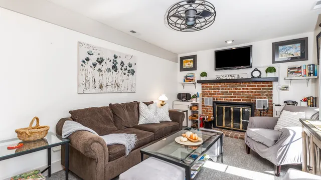 a living room with furniture a flat screen tv and a fireplace