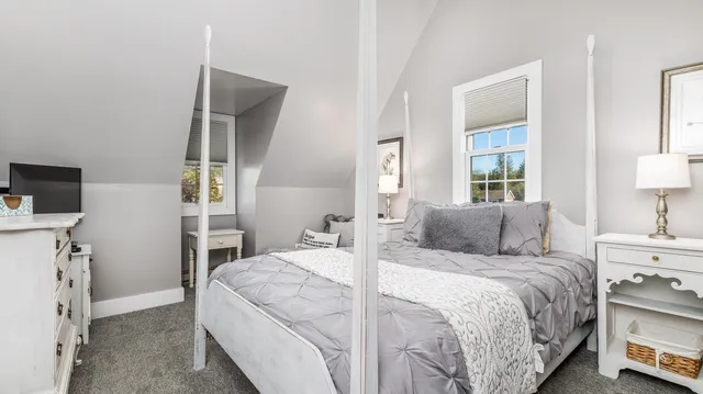 a bedroom with a bed and a tv on table
