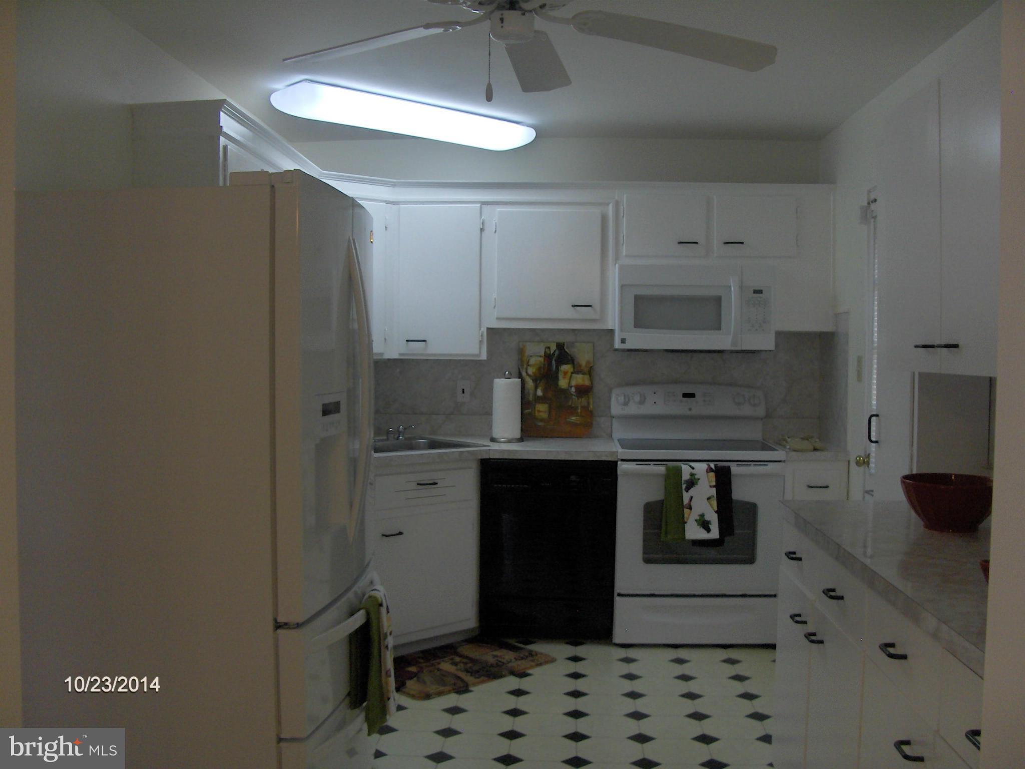 3306 May Street Silver Spring, MD 20906 - Photo 8 of 29 a kitchen with stainless steel appliances a stove refrigerator and cabinets