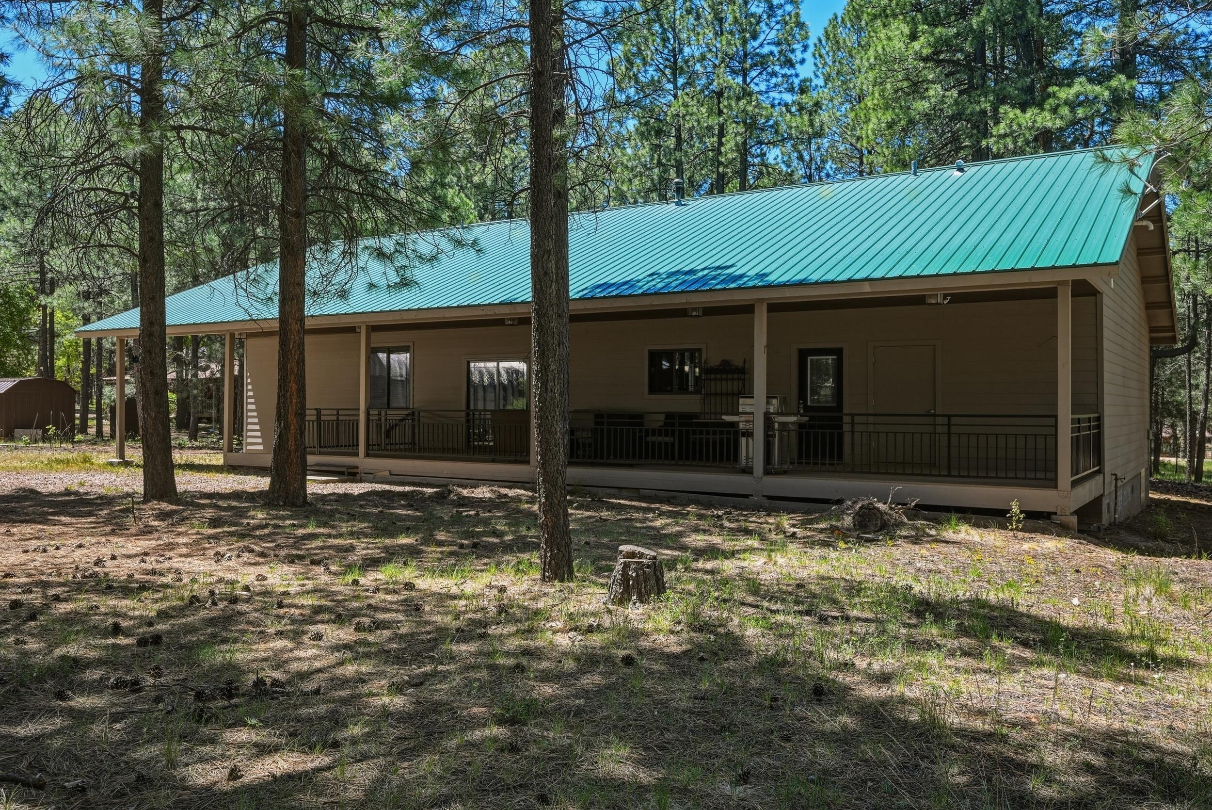 1233 Merzville Road Forest Lakes, AZ 85931 - Photo 28 of 39 a view of a barn in the middle of a yard