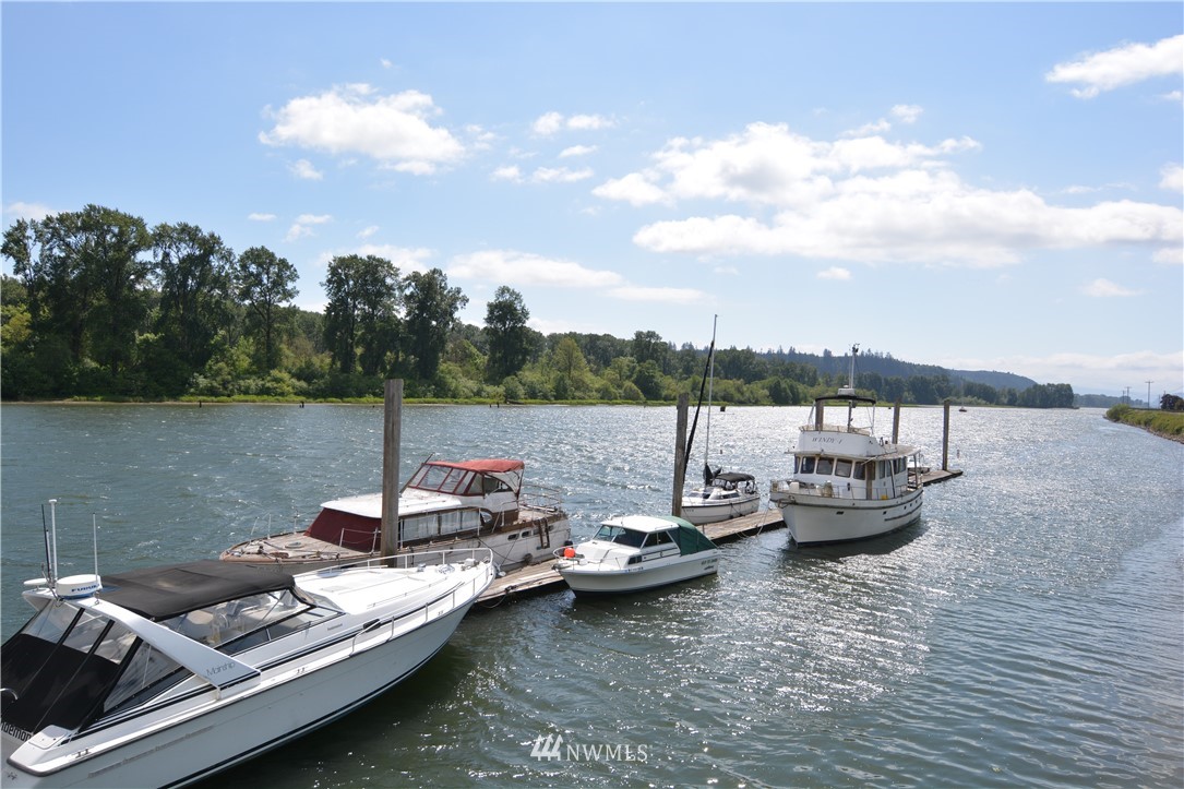 6400 B Willow Grove Road Longview, WA 98632 - Photo 15 of 26 a view of a lake with lawn chairs and a potted plant
