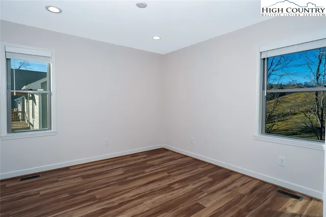 a view of a room with wooden floor and window