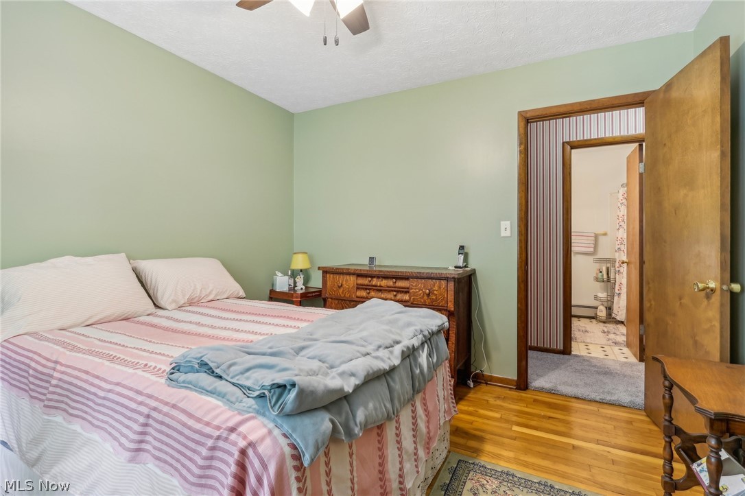 1762 Stonehaven Road Madison, OH 44057 - Photo 17 of 36 Bedroom with ceiling fan, light hardwood / wood-style floors, and baseboard heating