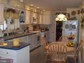134 Coleman Road Hamilton, NJ 08690 - Photo 2 of 6 a kitchen with stainless steel appliances granite countertop a sink a stove a dining table and chairs