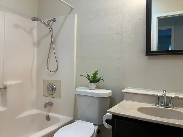a bathroom with a sink a toilet and a bathtub