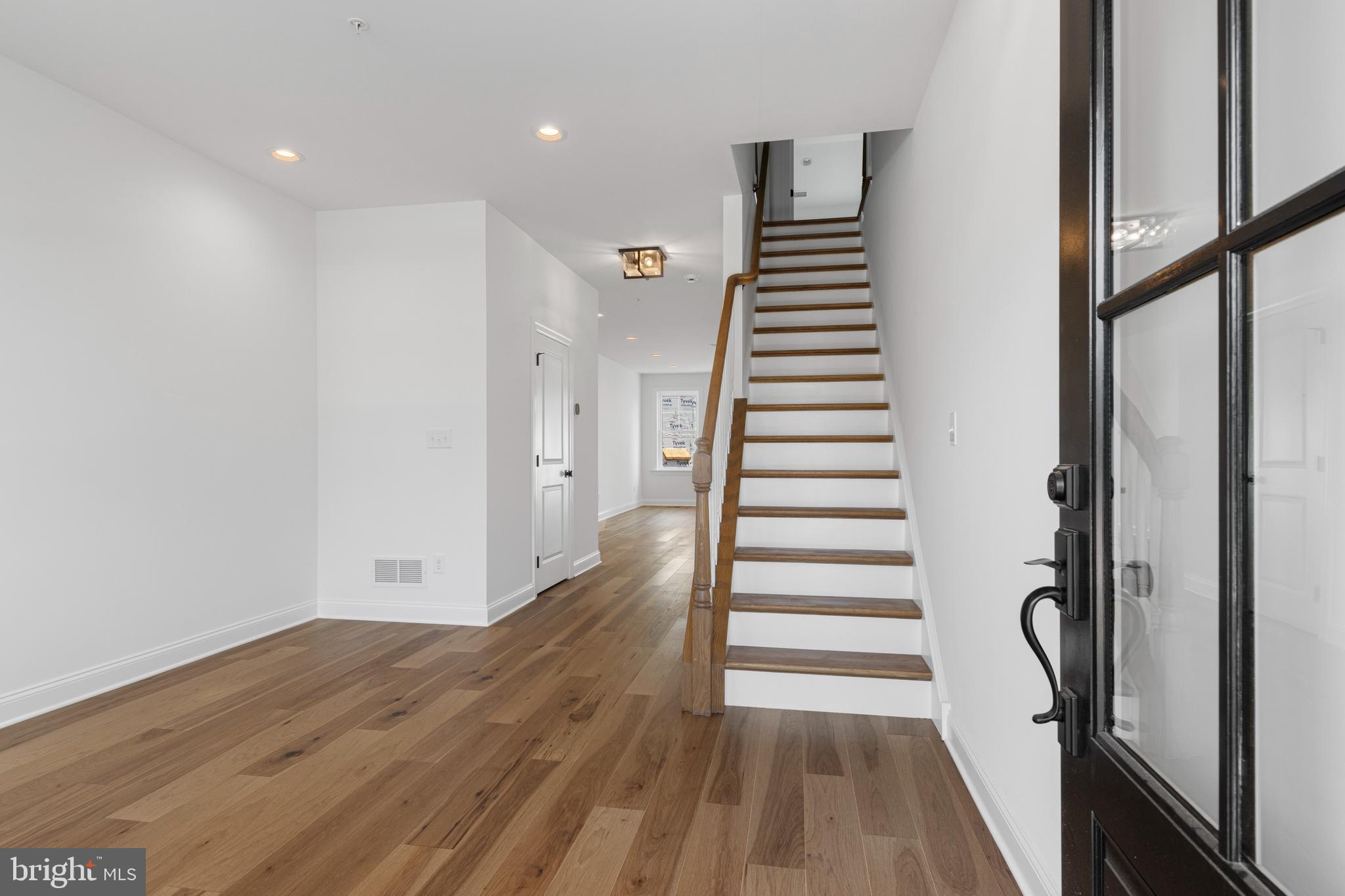 435 Reagans Lane, Unit 124 Chalfont, PA 18914 - Photo 3 of 8 a view of a hallway with wooden floor and stairs