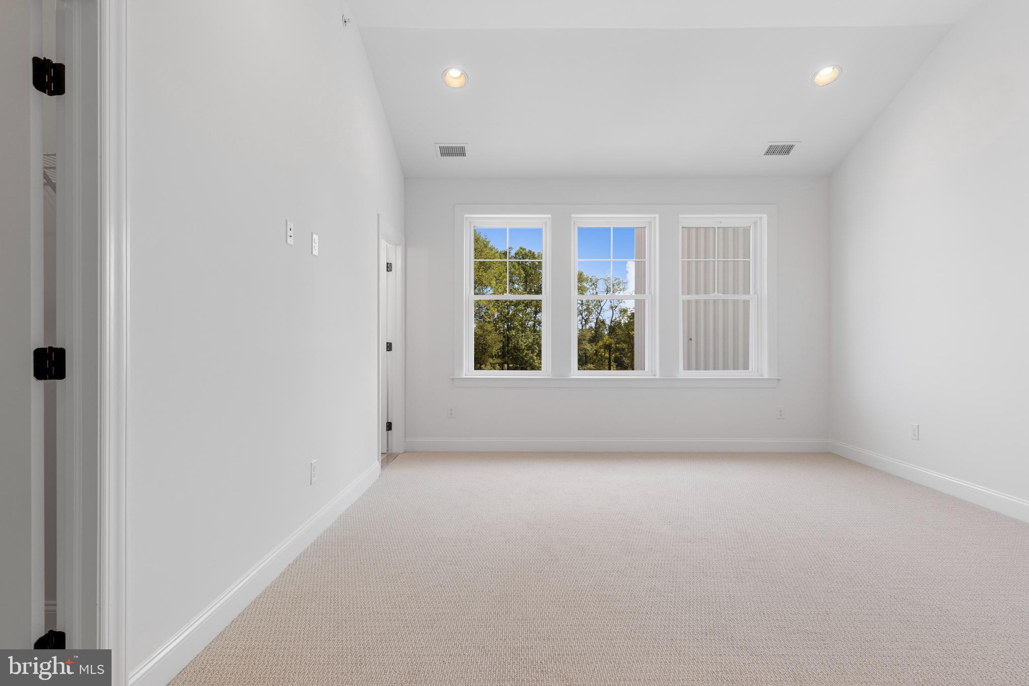 435 Reagans Lane, Unit 124 Chalfont, PA 18914 - Photo 7 of 8 an empty room with windows and closet