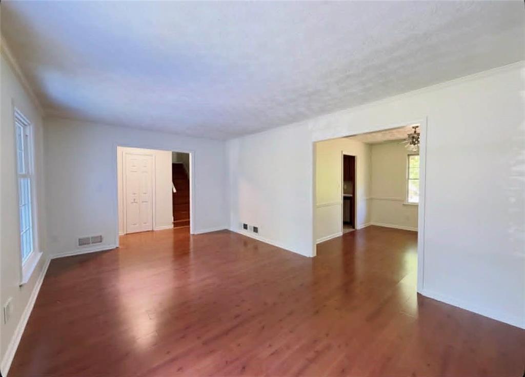 500 Rue De Chateau Stone Mountain, GA 30083 - Photo 3 of 17 a view of an empty room with wooden floor and a window