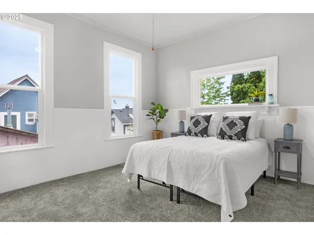 a bed sitting in a bedroom next to a window