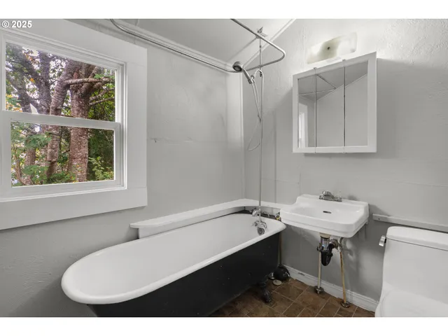 a bathroom with a sink mirror and a bathtub