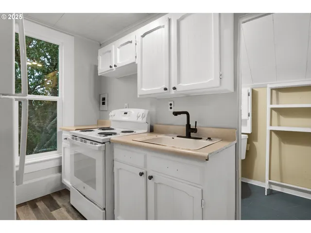 a kitchen with appliances cabinets and a sink