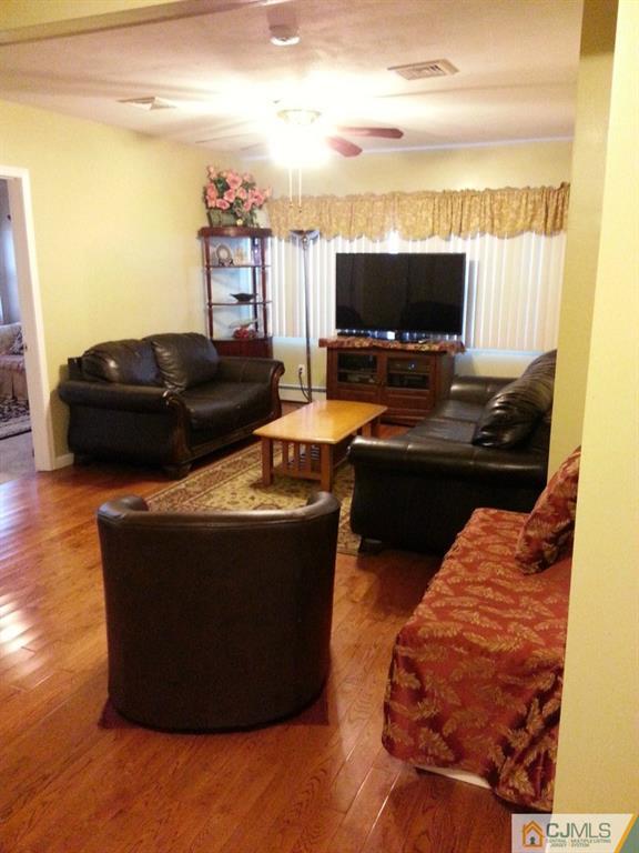 26 Winthrop Road Edison, NJ 08817 - Photo 17 of 25 a living room with furniture and a flat screen tv