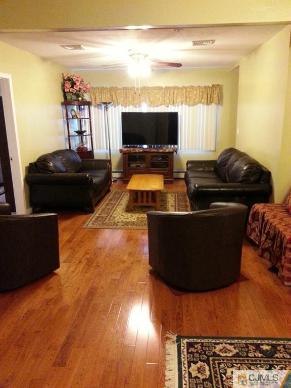26 Winthrop Road Edison, NJ 08817 - Photo 18 of 25 a living room with furniture and a flat screen tv