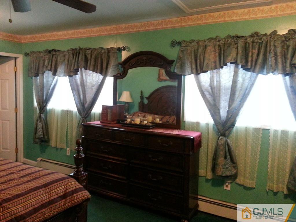 26 Winthrop Road Edison, NJ 08817 - Photo 5 of 25 a bedroom with a bed a mirror and a window