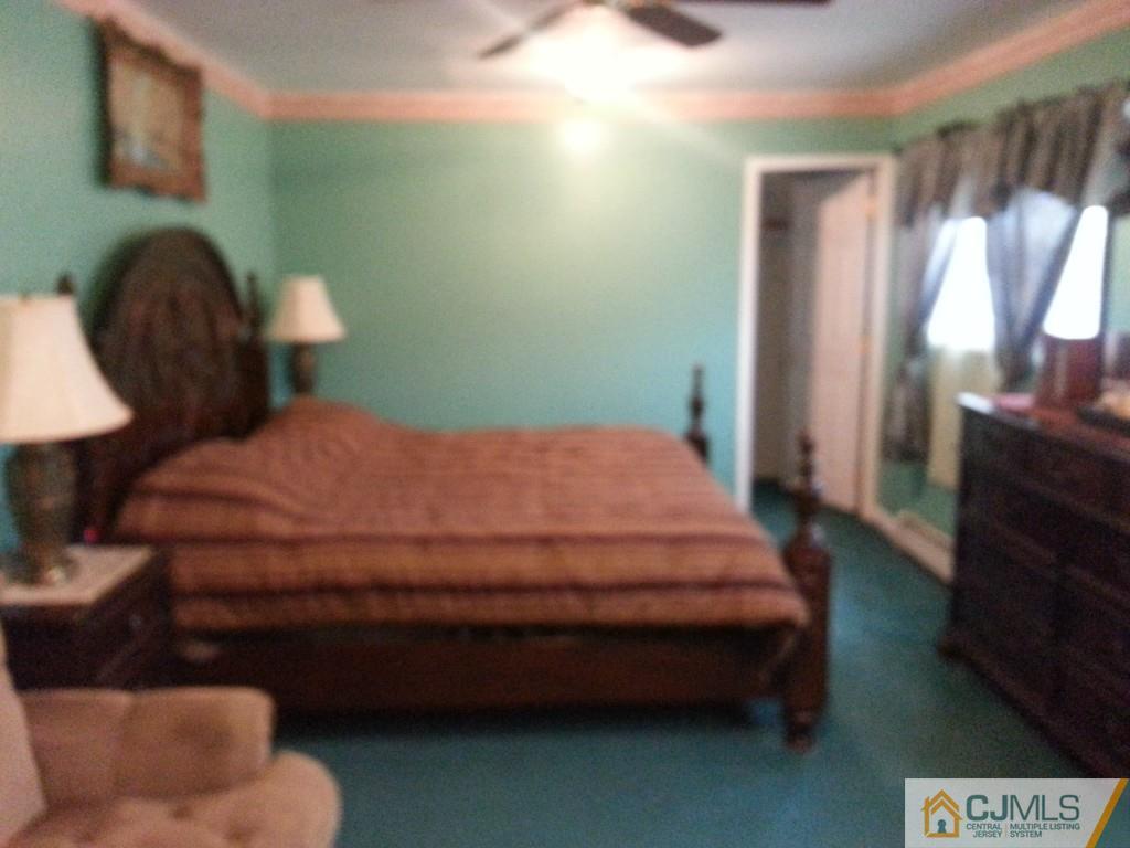 26 Winthrop Road Edison, NJ 08817 - Photo 6 of 25 a bed sitting in a bedroom next to a window