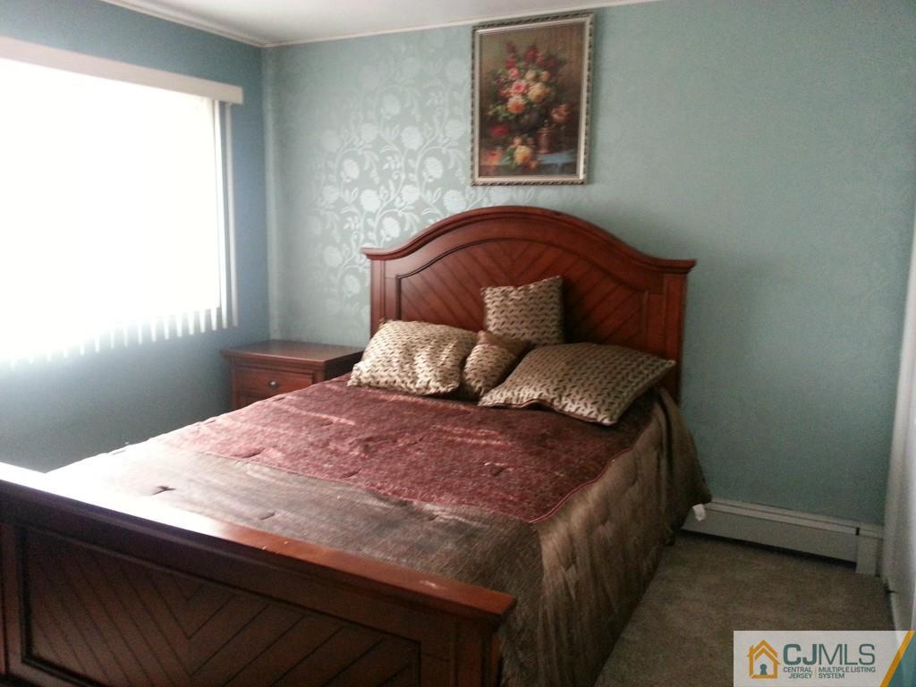 26 Winthrop Road Edison, NJ 08817 - Photo 7 of 25 a bed sitting in a bedroom next to a window