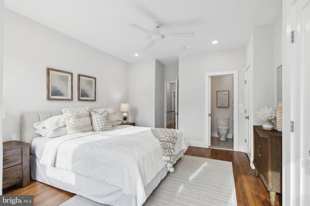 a bedroom with a bed and a painting