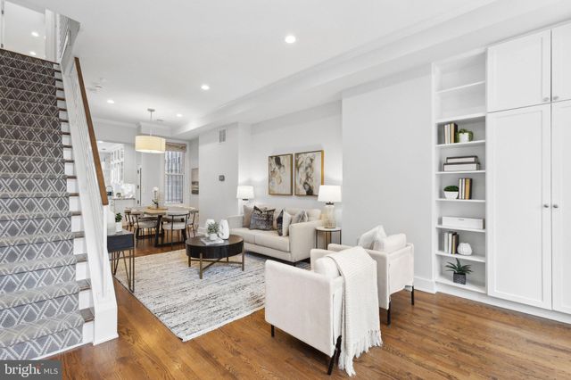 a living room with furniture and a book shelf