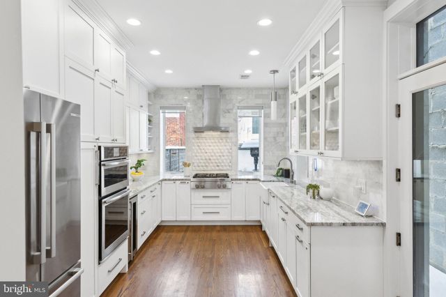 a kitchen with a refrigerator sink and cabinets