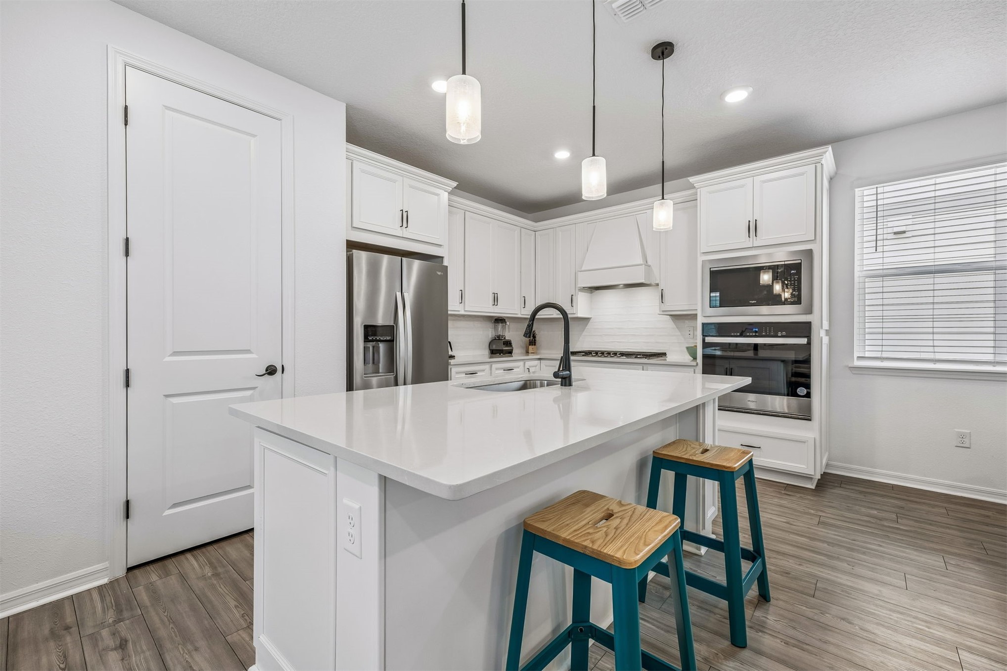 236 Hawthorn Park Circle Yulee, FL 32097 - Photo 7 of 28 a kitchen with white cabinets and stainless steel appliances