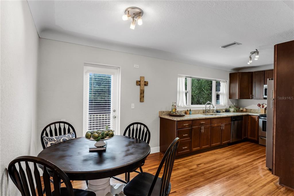2425 36th Avenue North St. Petersburg, FL 33713 - Photo 13 of 32 a kitchen with stainless steel appliances granite countertop a dining table and chairs