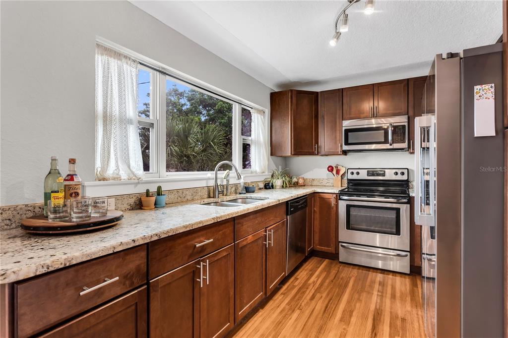 2425 36th Avenue North St. Petersburg, FL 33713 - Photo 15 of 32 a kitchen with a sink stove and microwave