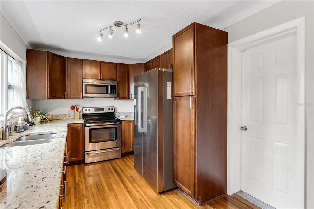 2425 36th Avenue North St. Petersburg, FL 33713 - Photo 16 of 32 a kitchen with granite countertop a refrigerator and a sink