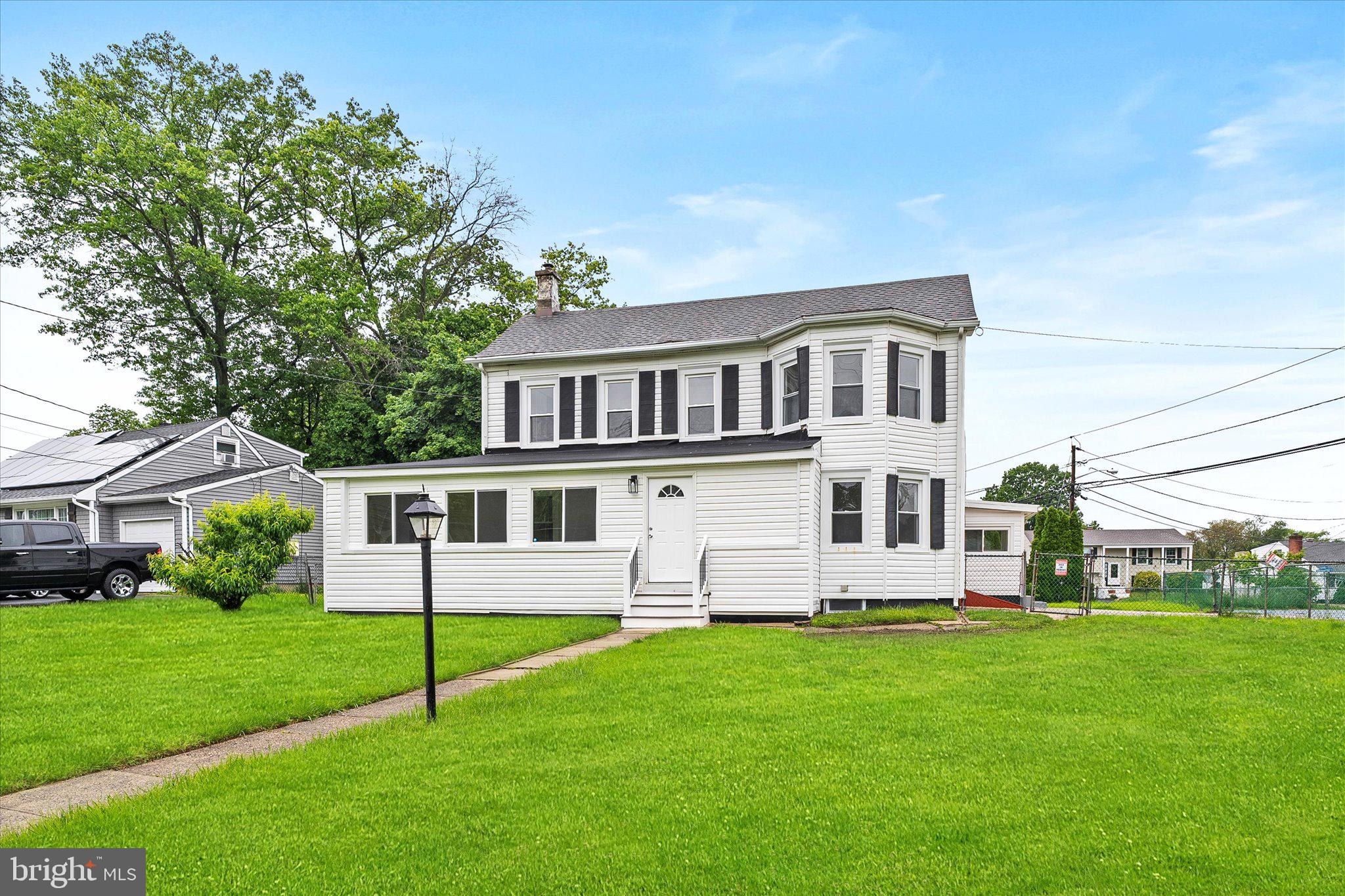 a front view of a house with a garden and yard