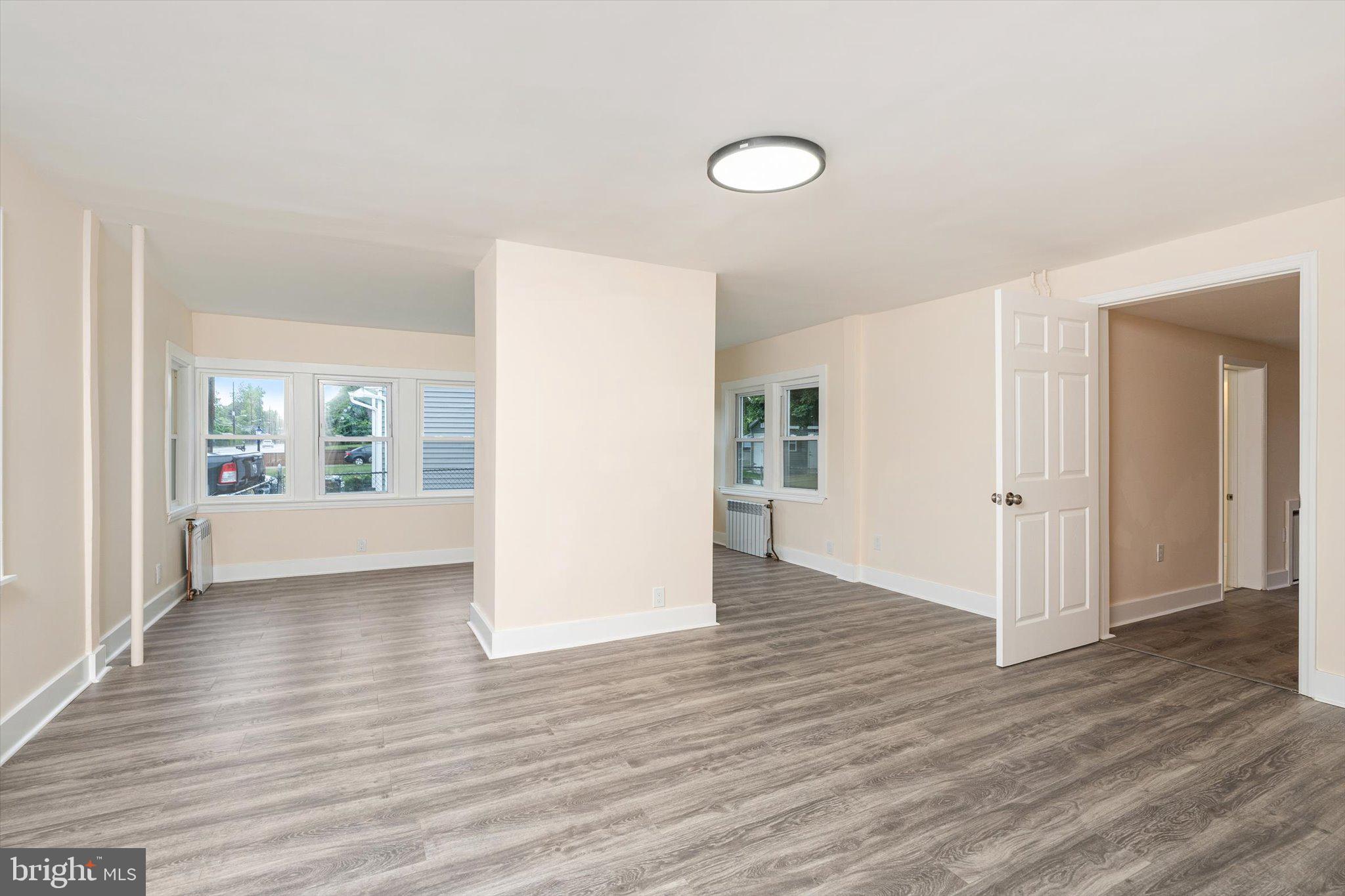 542 Mercerville-Edinburg Road Trenton, NJ 08619 - Photo 12 of 31 a view of an empty room with wooden floor and a window