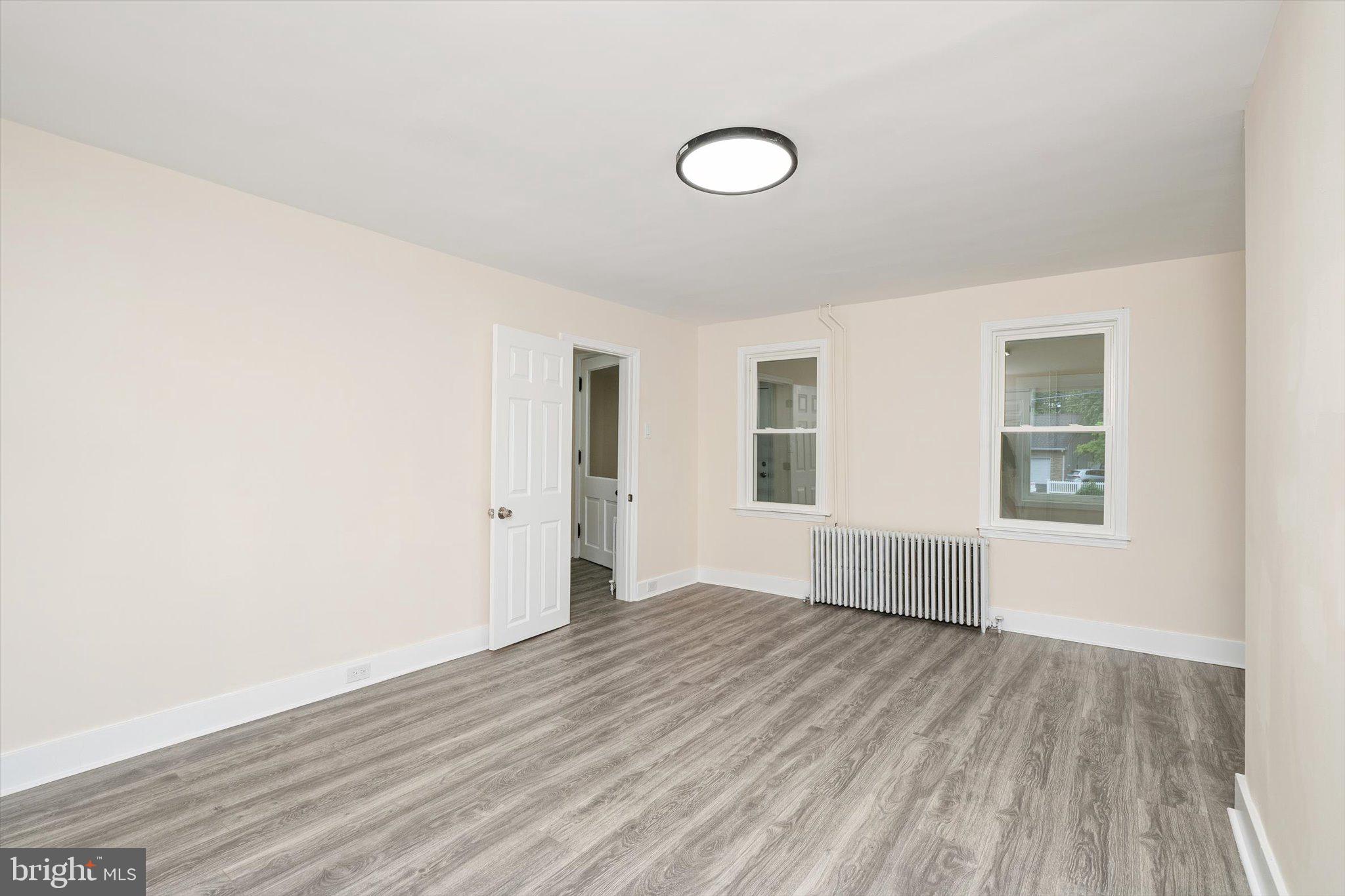 542 Mercerville-Edinburg Road Trenton, NJ 08619 - Photo 13 of 31 an empty room with wooden floor and windows