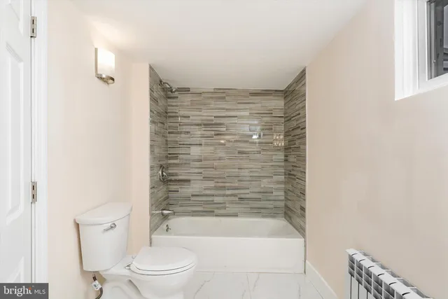 a bathroom with a bathtub and a toilet