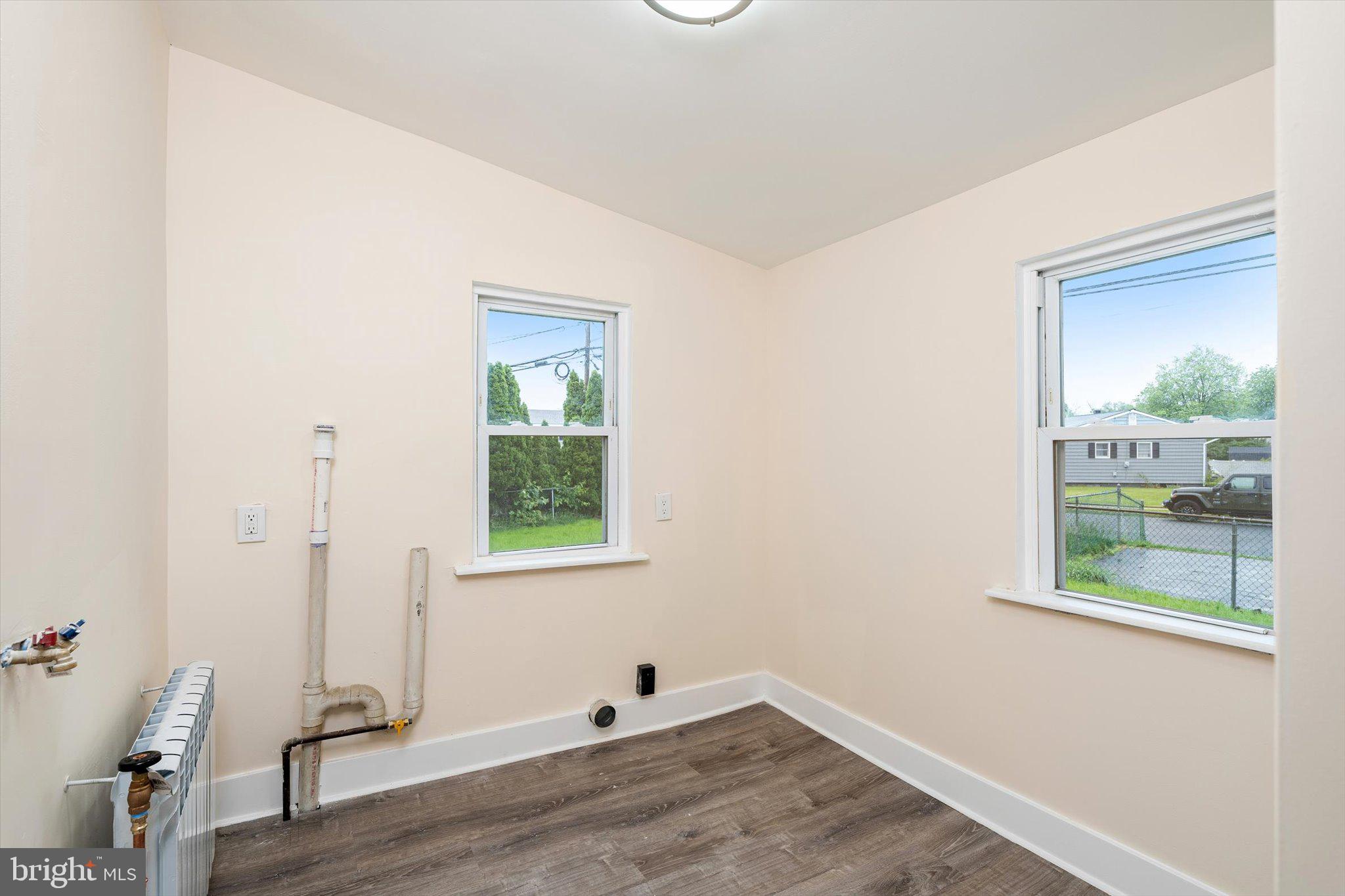 542 Mercerville-Edinburg Road Trenton, NJ 08619 - Photo 16 of 31 a view of an empty room with wooden floor and a window