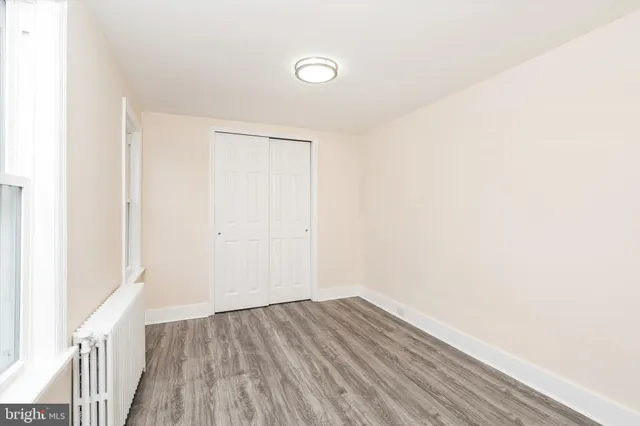 a view of a room with wooden floor