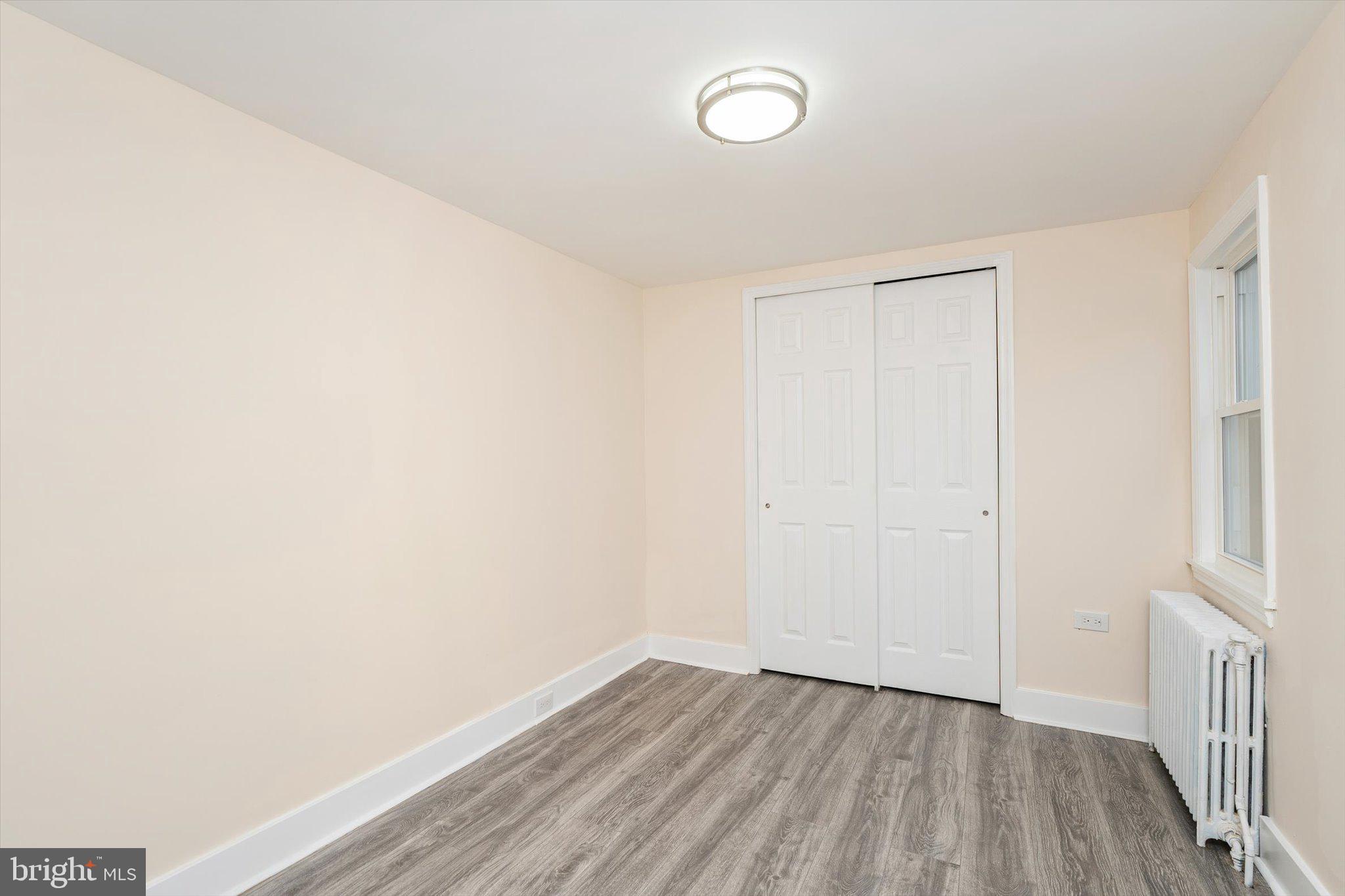 542 Mercerville-Edinburg Road Trenton, NJ 08619 - Photo 21 of 31 a view of an empty room with wooden floor and a window