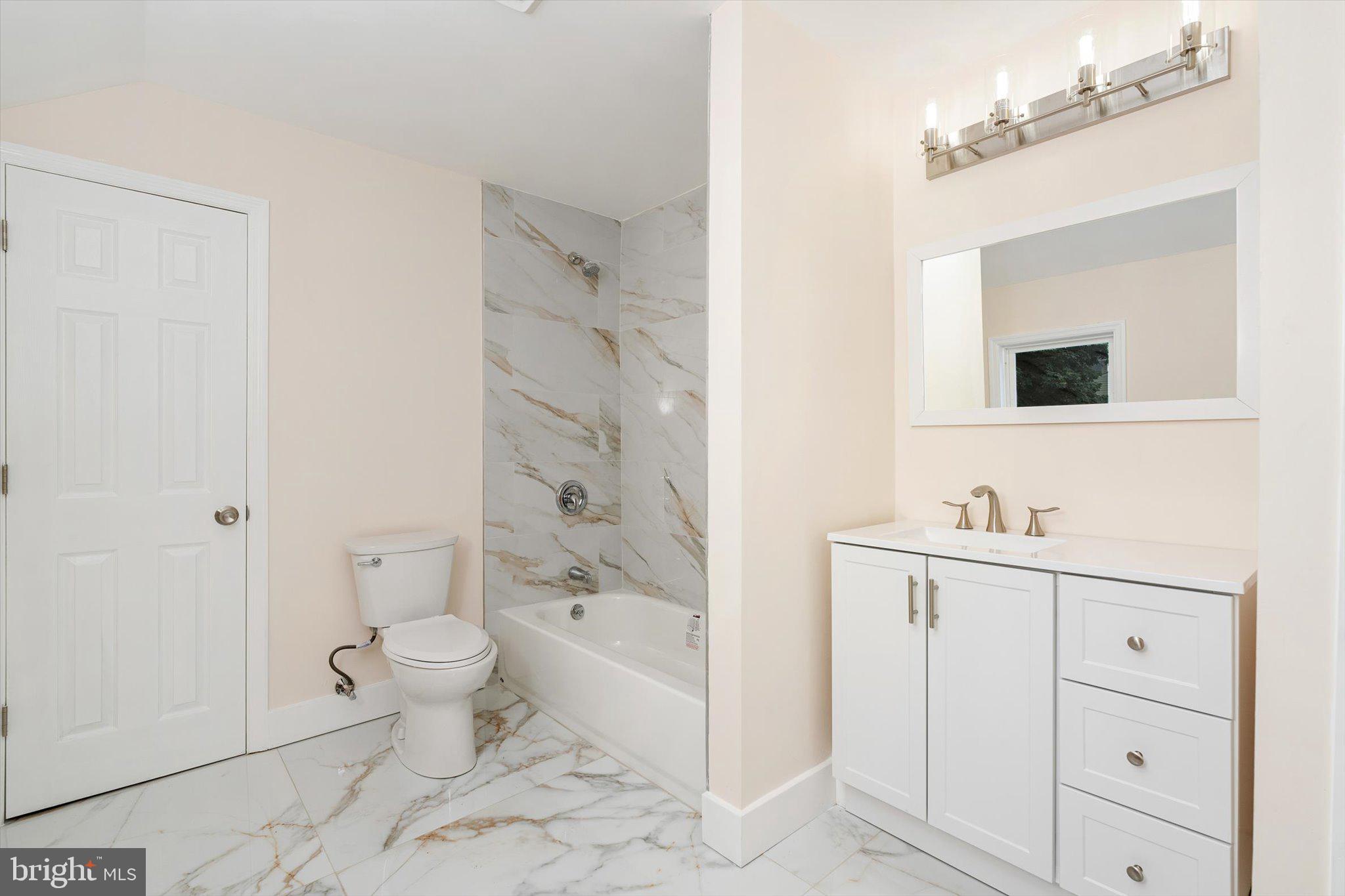 542 Mercerville-Edinburg Road Trenton, NJ 08619 - Photo 23 of 31 a bathroom with a sink a toilet and a mirror