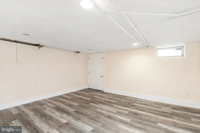 a view of a room with wooden floor