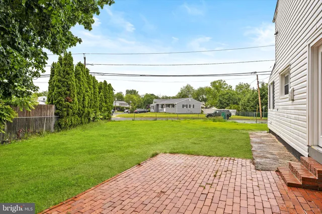 a view of backyard with garden and outdoor seating
