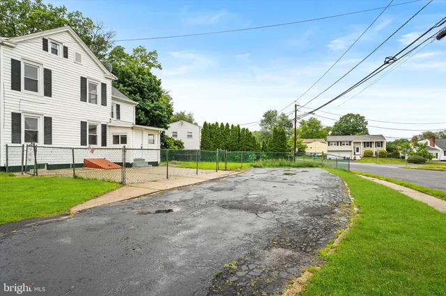 a view of a house with a yard and many windows