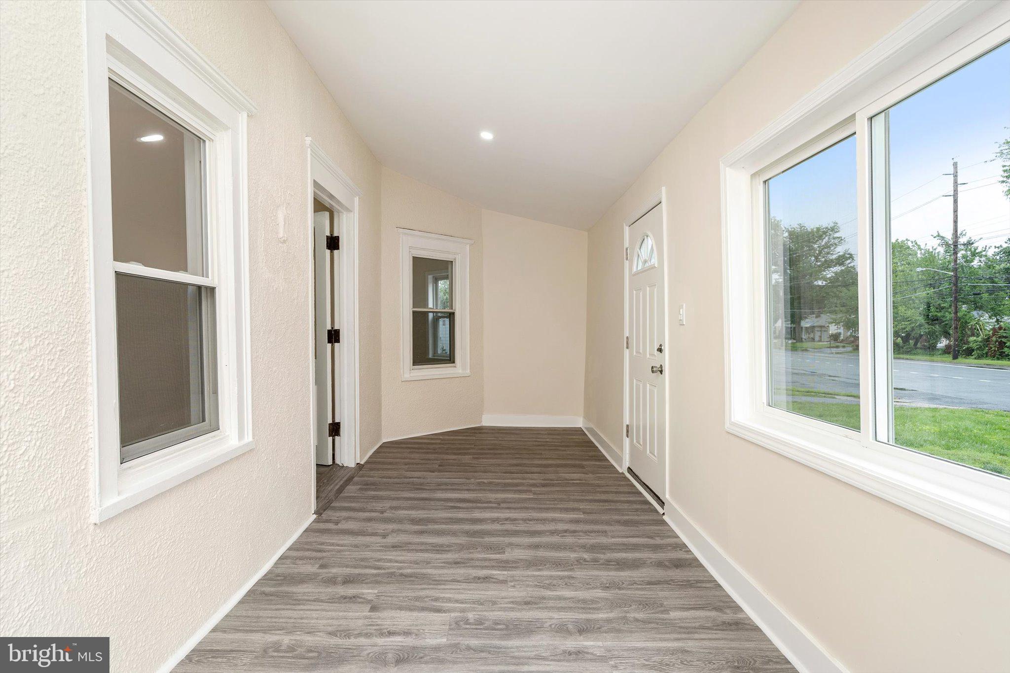 542 Mercerville-Edinburg Road Trenton, NJ 08619 - Photo 4 of 31 a view of a hallway with wooden floor and windows