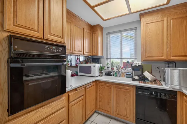 a kitchen with sink cabinets and appliances