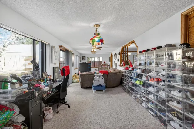 a very nice looking room with many windows and furniture