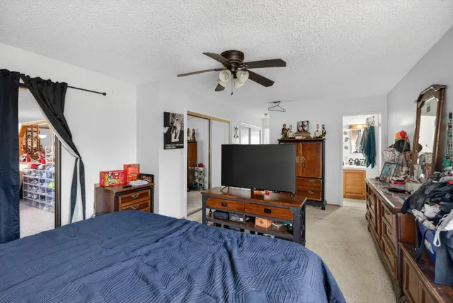 a bedroom with furniture and a flat screen tv