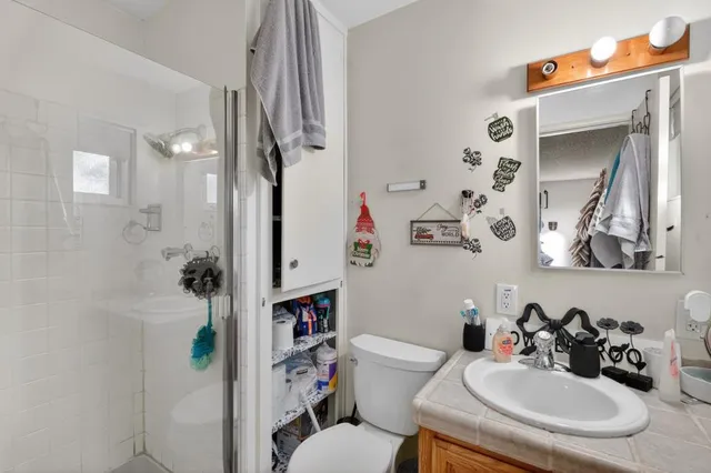 a bathroom with a sink toilet and shower