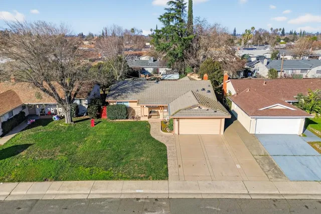 an aerial view of a house with a yard